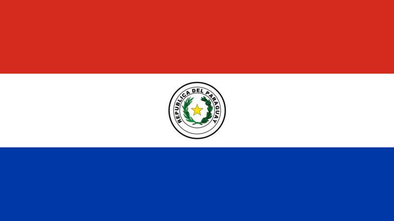 Paraguay flag with emblem, highlighting affordable 2026 relocation: $913 USD living costs excl. rent, investor visas via SUACE & crypto-friendly policies.